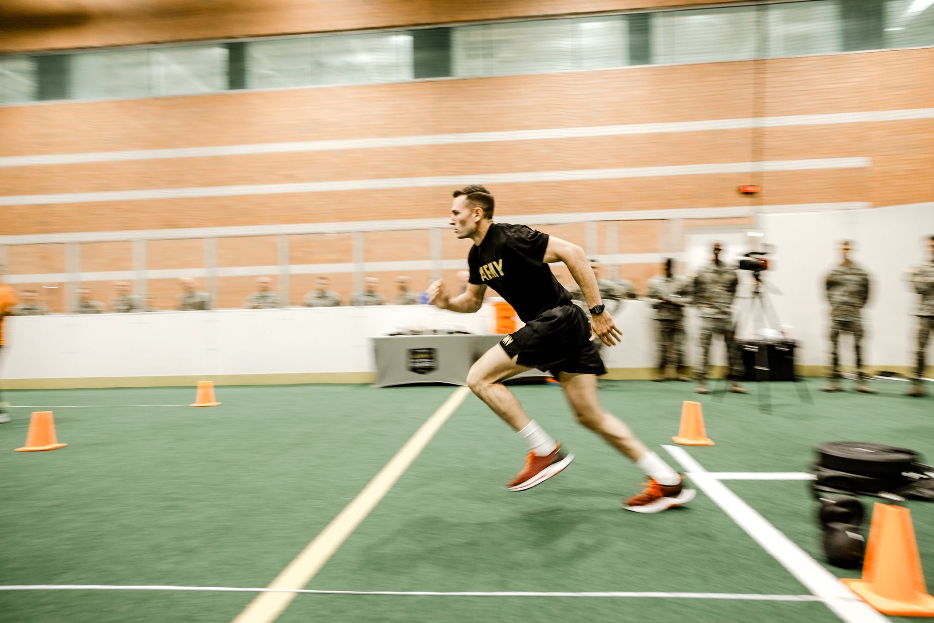 Captivating shot of an army soldier sprinting during fitness test indoors.