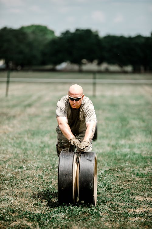 Free A Soldier Rolling a Wheel on Grass Stock Photo