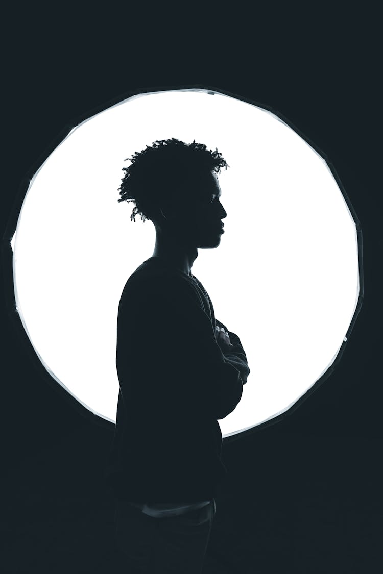 A Silhouette Of A Man With Curly Hair