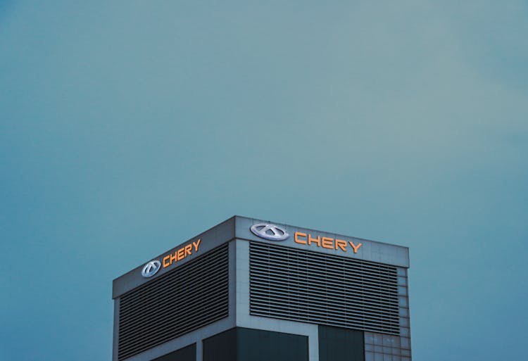 A Building With A Logo Under A Clear Sky