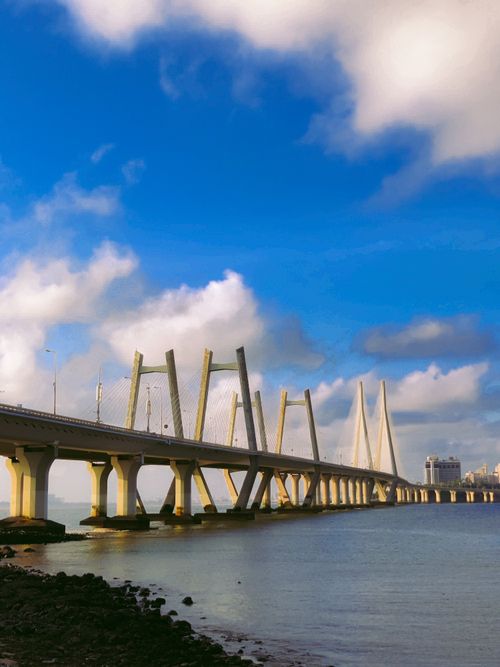 Free Stunning view of the Bandra Worli Sea Link bridge in Mumbai against a bright blue sky and white clouds. Stock Photo