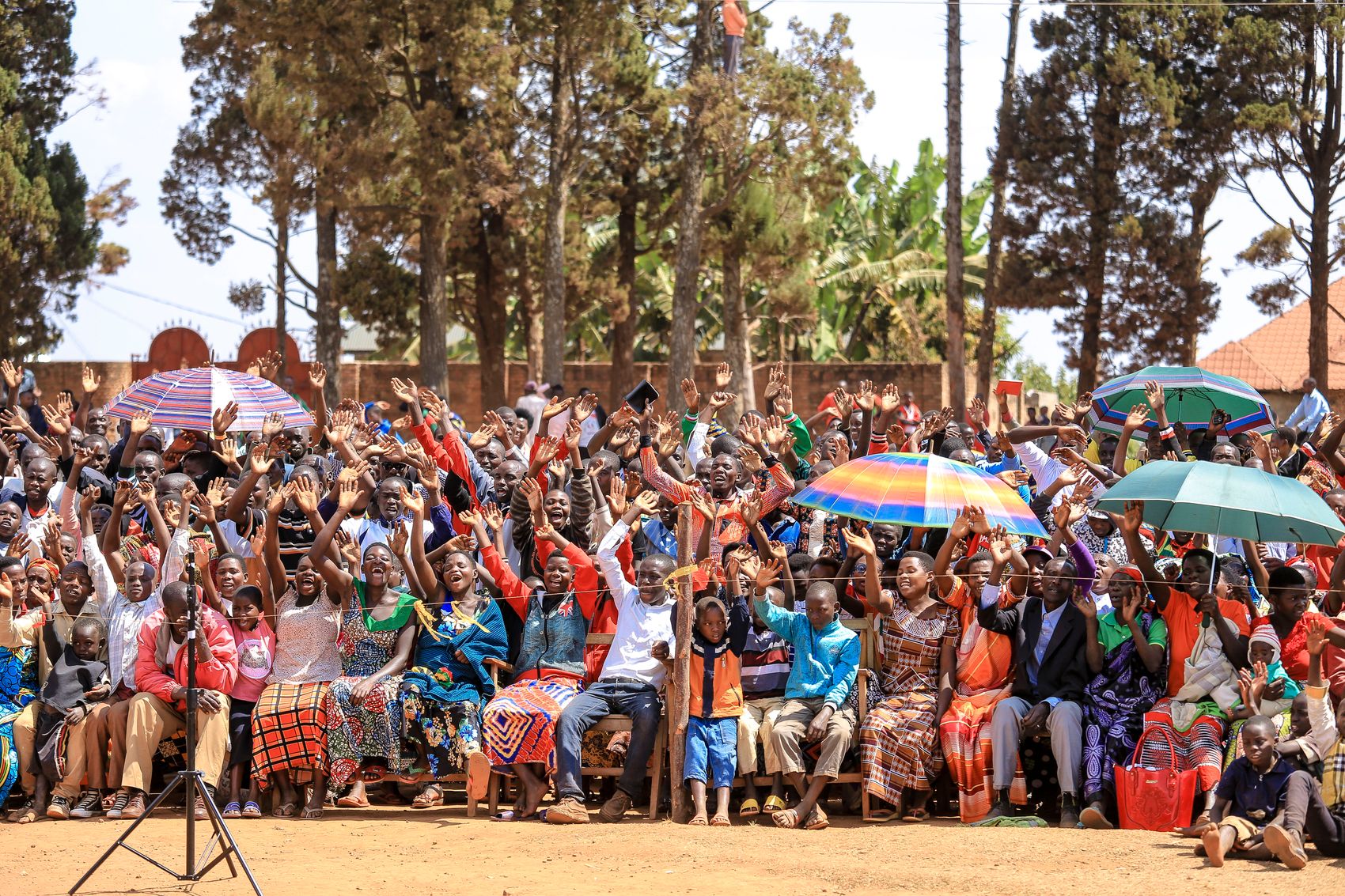 Crowd raising their hands during an outdoor gathering