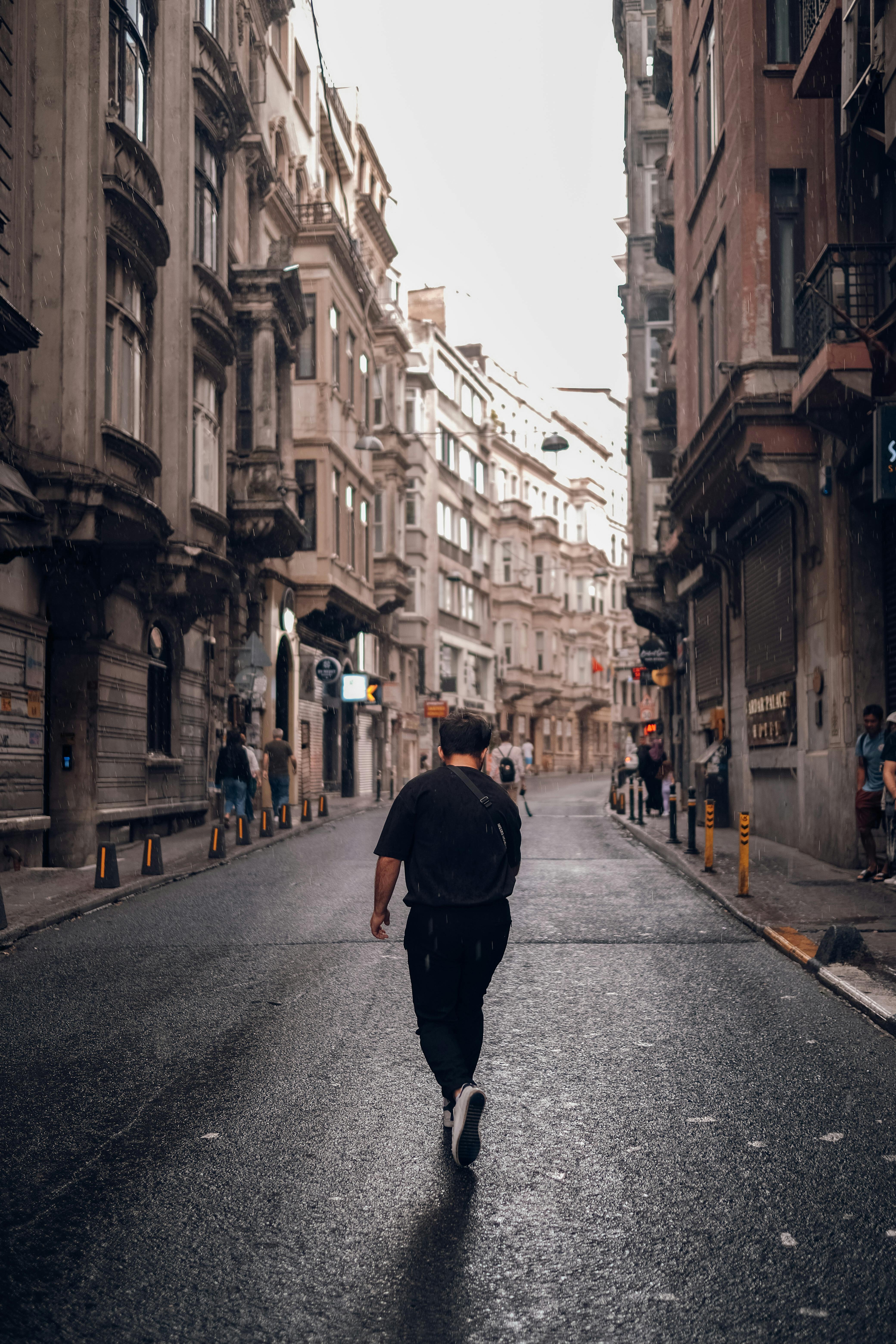 Person in black shirt walking on street