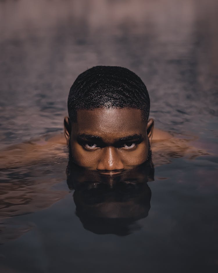 Man With Half Of His Face Submerged In Water 