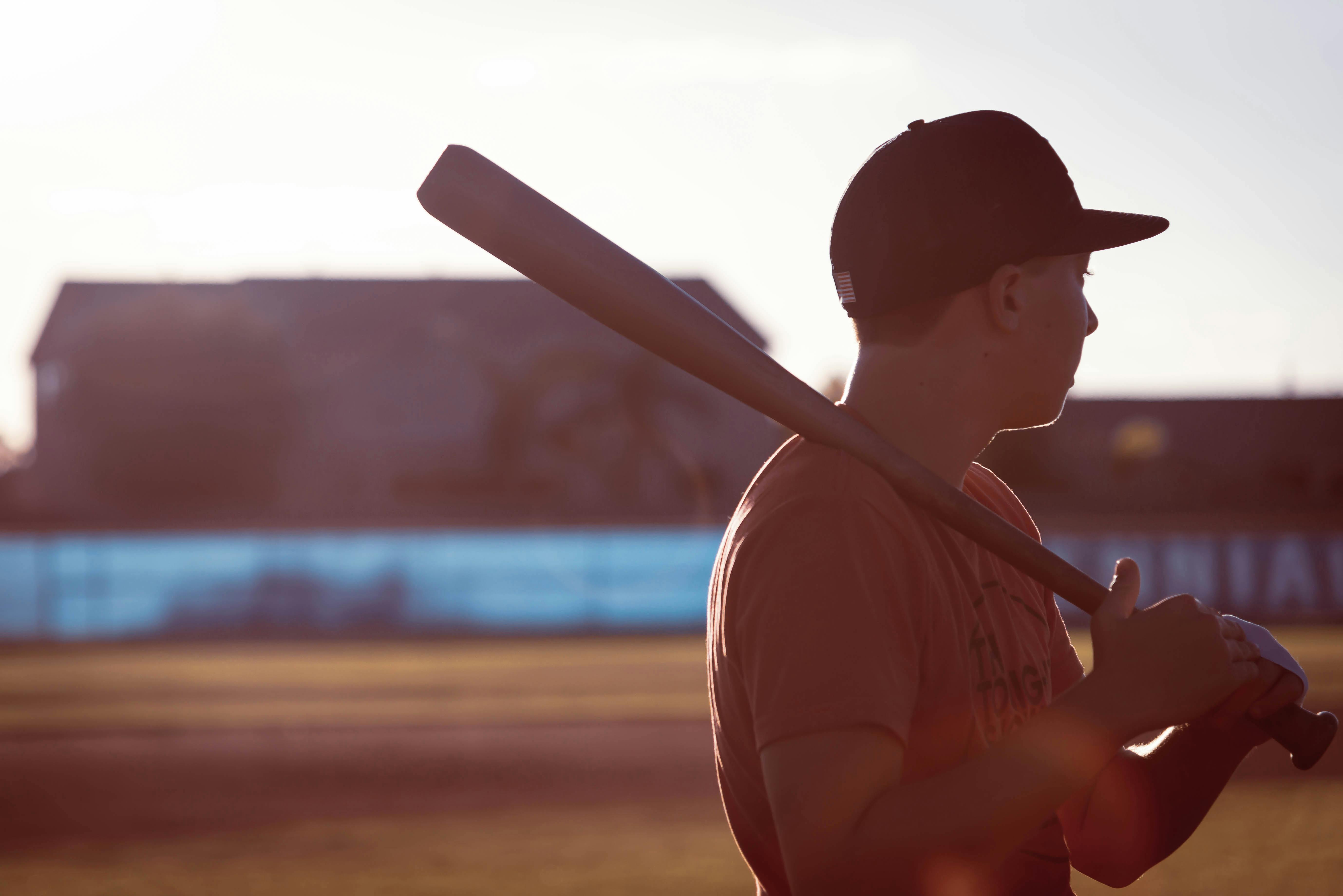 Download A Man In Pink Baseball Gear Is Standing On A Field Wallpaper