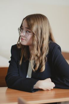 Faculty member sitting in a classroom environment
