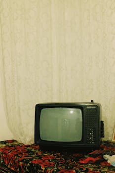Old-style television on a floral cloth, evoking nostalgia and retro charm.