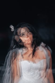 Creative and artistic portrait of a bride in a white dress with blurred motion effect.