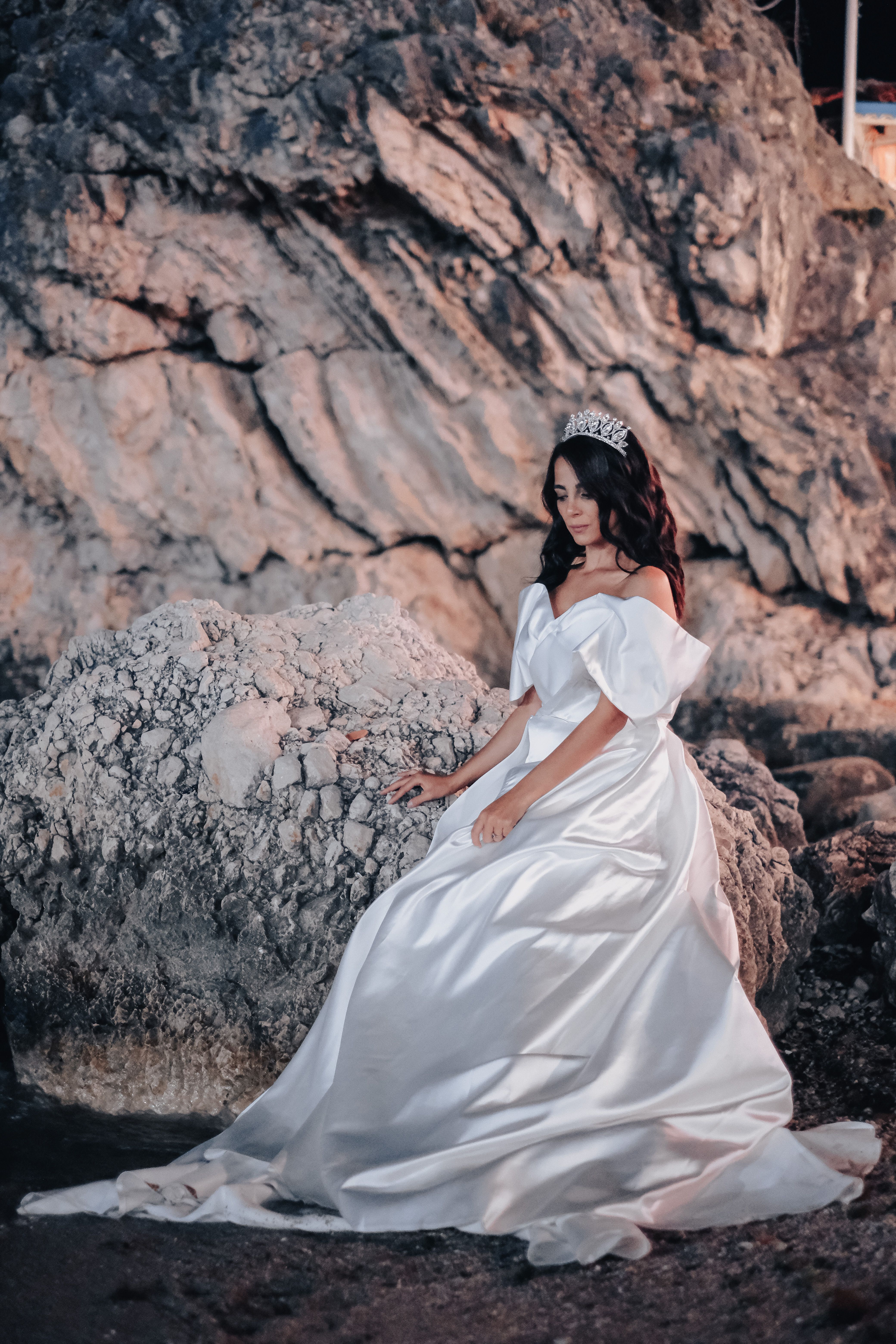 Woman in White Dress Sitting on Brown Rock · Free Stock Photo