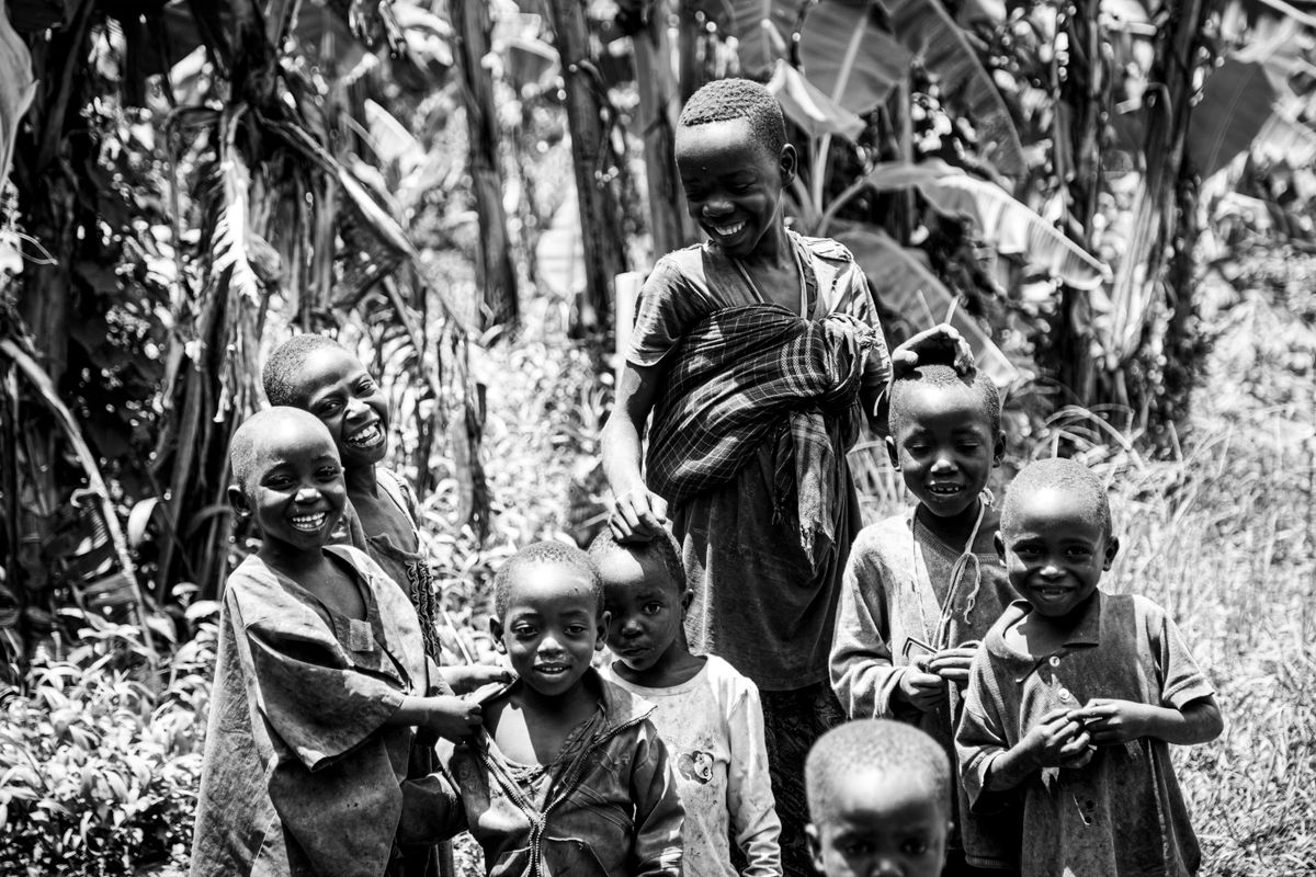 A vibrant group of children smiling amidst lush nature