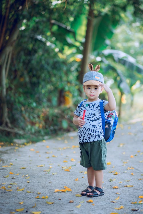 Free Boy Wearing Shirt and Shorts on Road Stock Photo