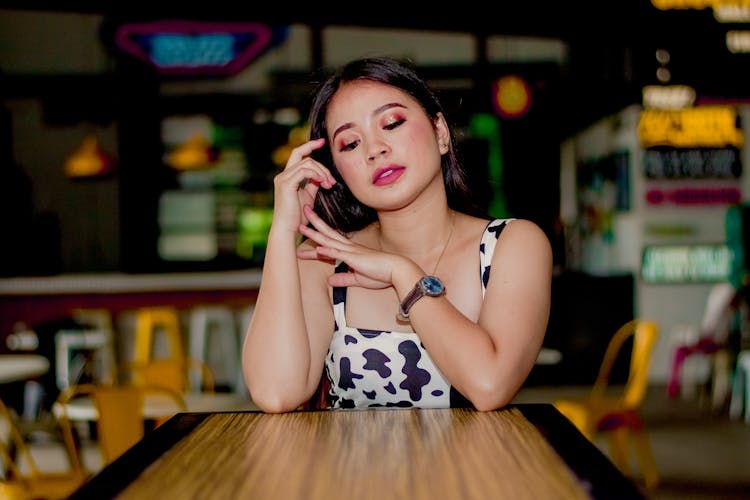 Beautiful Woman Sitting Behing Bar Table