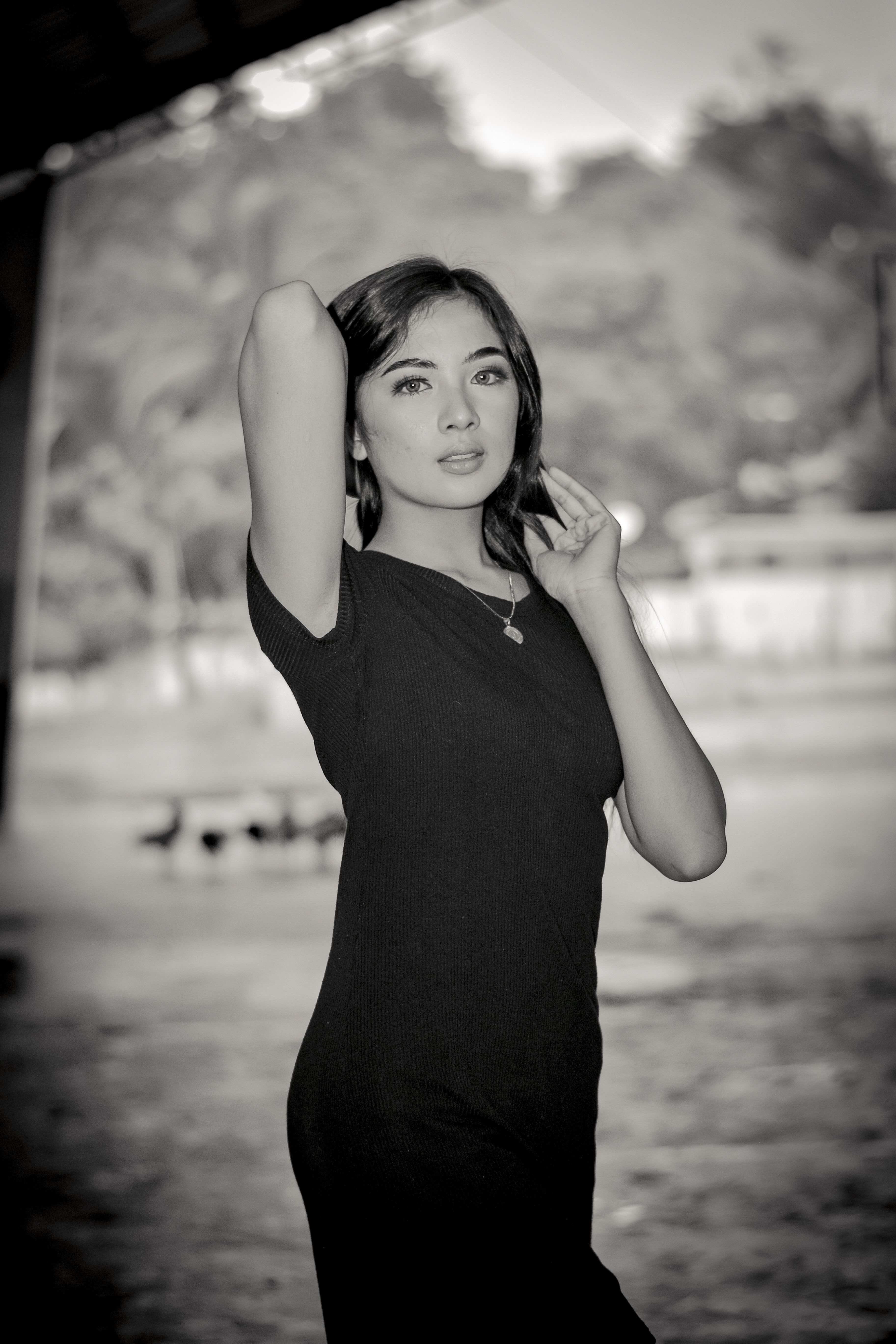 Grayscale Photo of a Woman in a Black Dress · Free Stock Photo