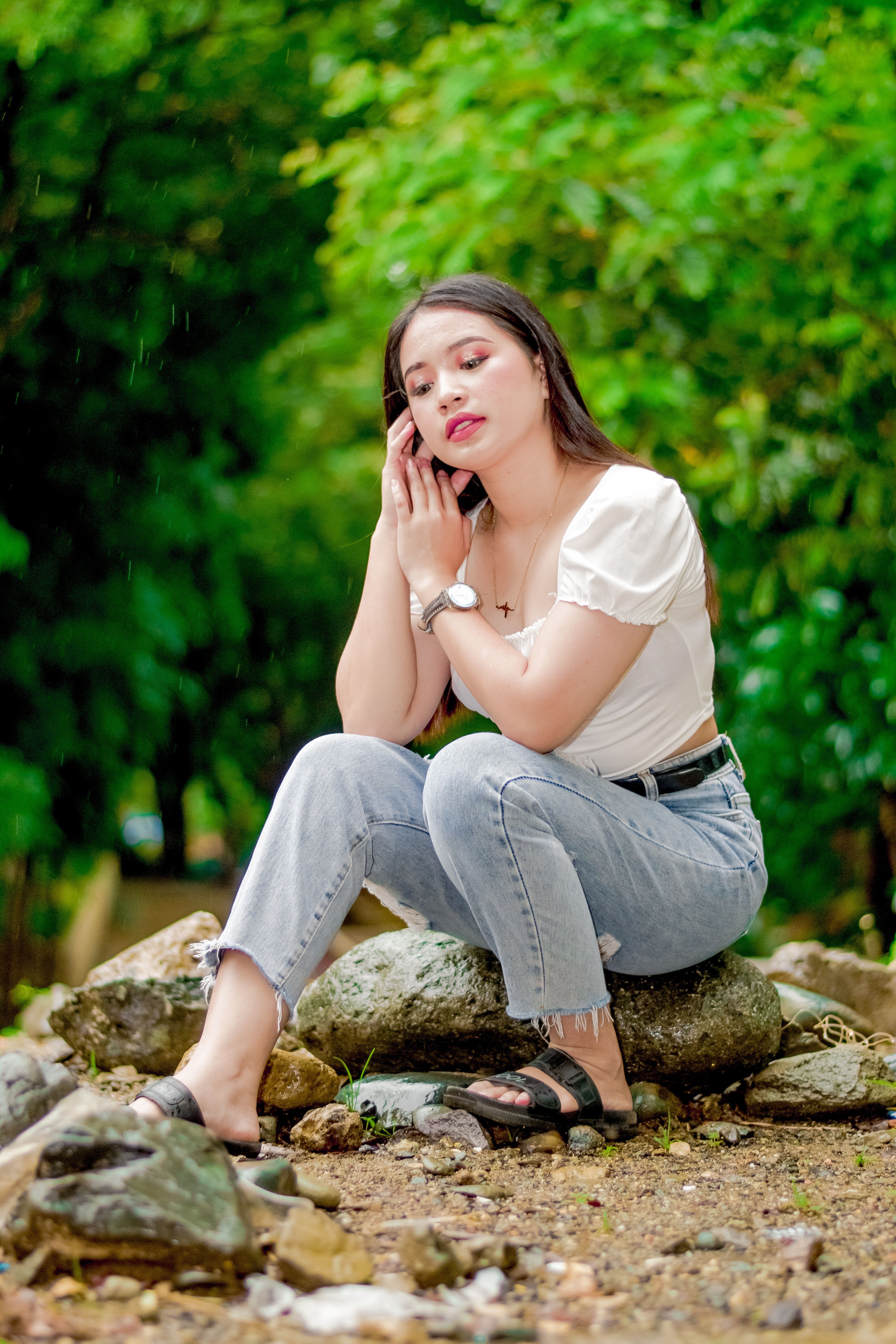 Woman in Denim Jacket Sitting on the Edge of a Big Rog · Free Stock Photo