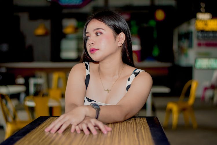 Young Brunette Sitting At A Table A Restaurant 