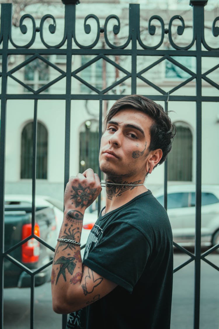 A Tattooed Man In A Black Shirt 