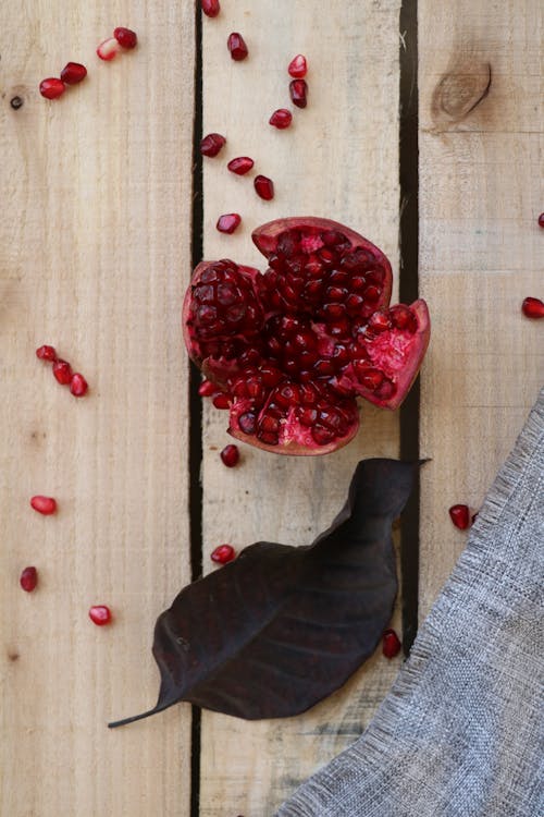 Overhead Shot of a Pomegranate Near a Leaf