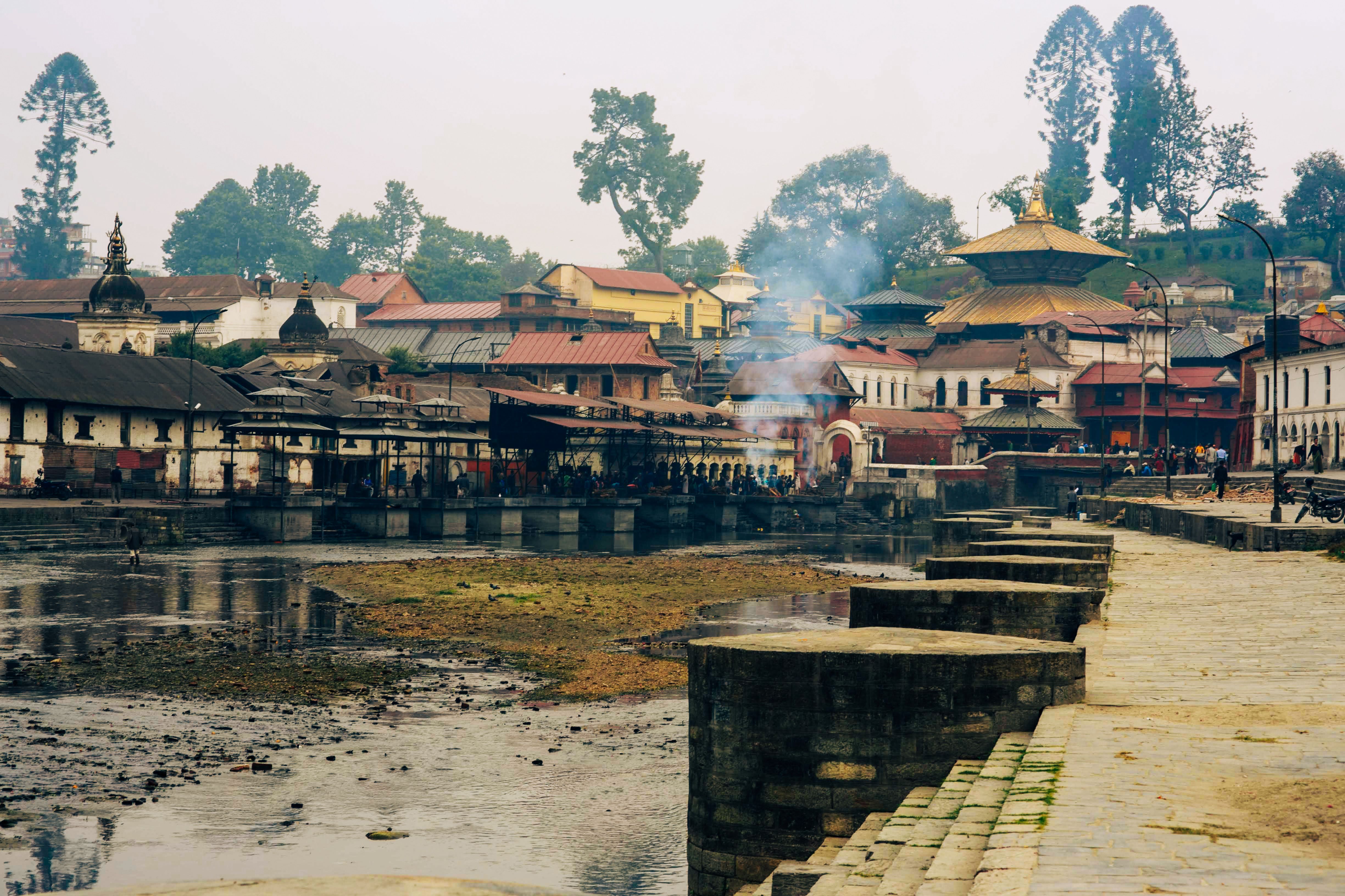 Scenic view of historic Pashupatinath Temple and riverbank in Kathmandu, rich in cultural heritage.