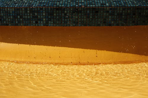 View of Water Dripping from a Swimming Pool Edge 