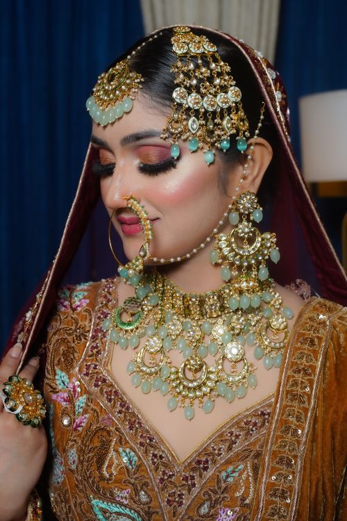Free A woman elegantly dressed in traditional bridal attire adorned with exquisite jewelry, showcasing cultural richness. Stock Photo