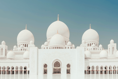 Free Stunning view of a mosque with elegant domes against a clear sky, showcasing Islamic architecture. Stock Photo