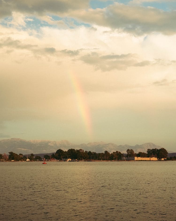 Rainbow Under Clouds