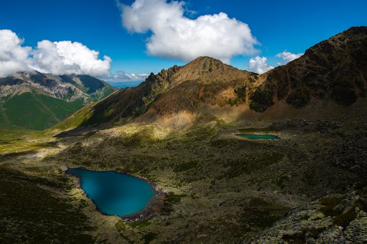 Lake In The Mountains Under Blue Sky