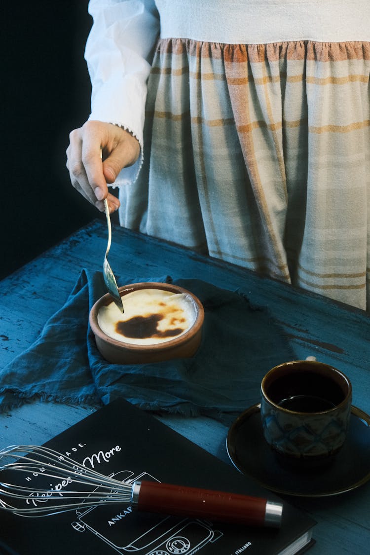 Woman Eating Traditional Dessert With Spoon