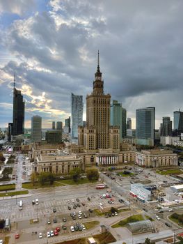 Aerial view of the Palace of Culture and Science surrounded by modern skyscrapers in Warsaw.