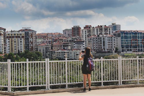 Woman Holding A Smartphone Taking Photos Of Buildings