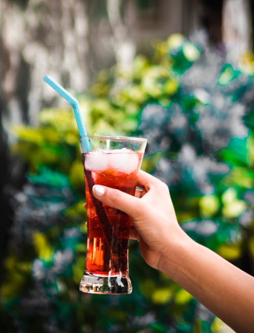 Hand Holding Drink with Straw