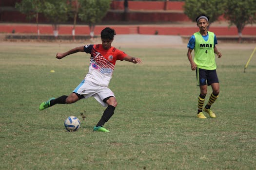 Two soccer players in action on the field during a match, showcasing athleticism.