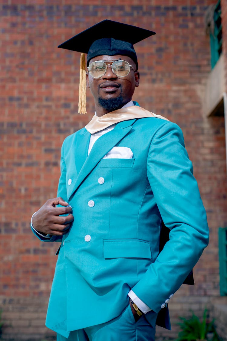 Graduate In Blue Suit And Academic Hat