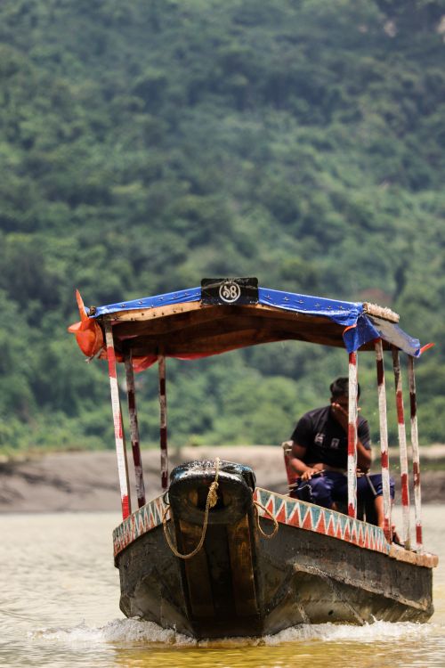 Free A scenic view of a traditional boat on the Surma River in Sylhet, Bangladesh. Stock Photo