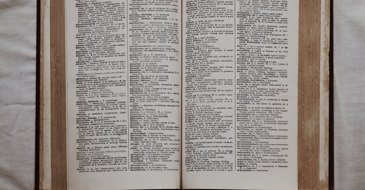 Close-up of an open dictionary showing English and Spanish translations, flat lay view.