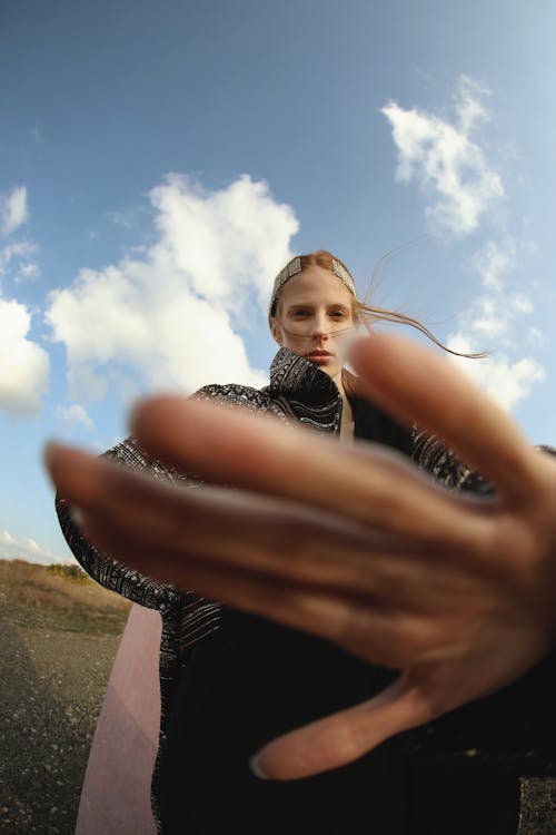 Woman Trying to Cover the Camera with Her Hand 