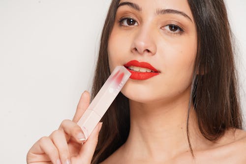 Portrait of a Woman Holding a Lipstick Box