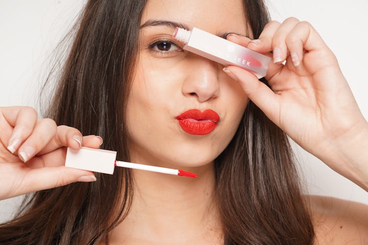 A Woman Holding Red Lipstick