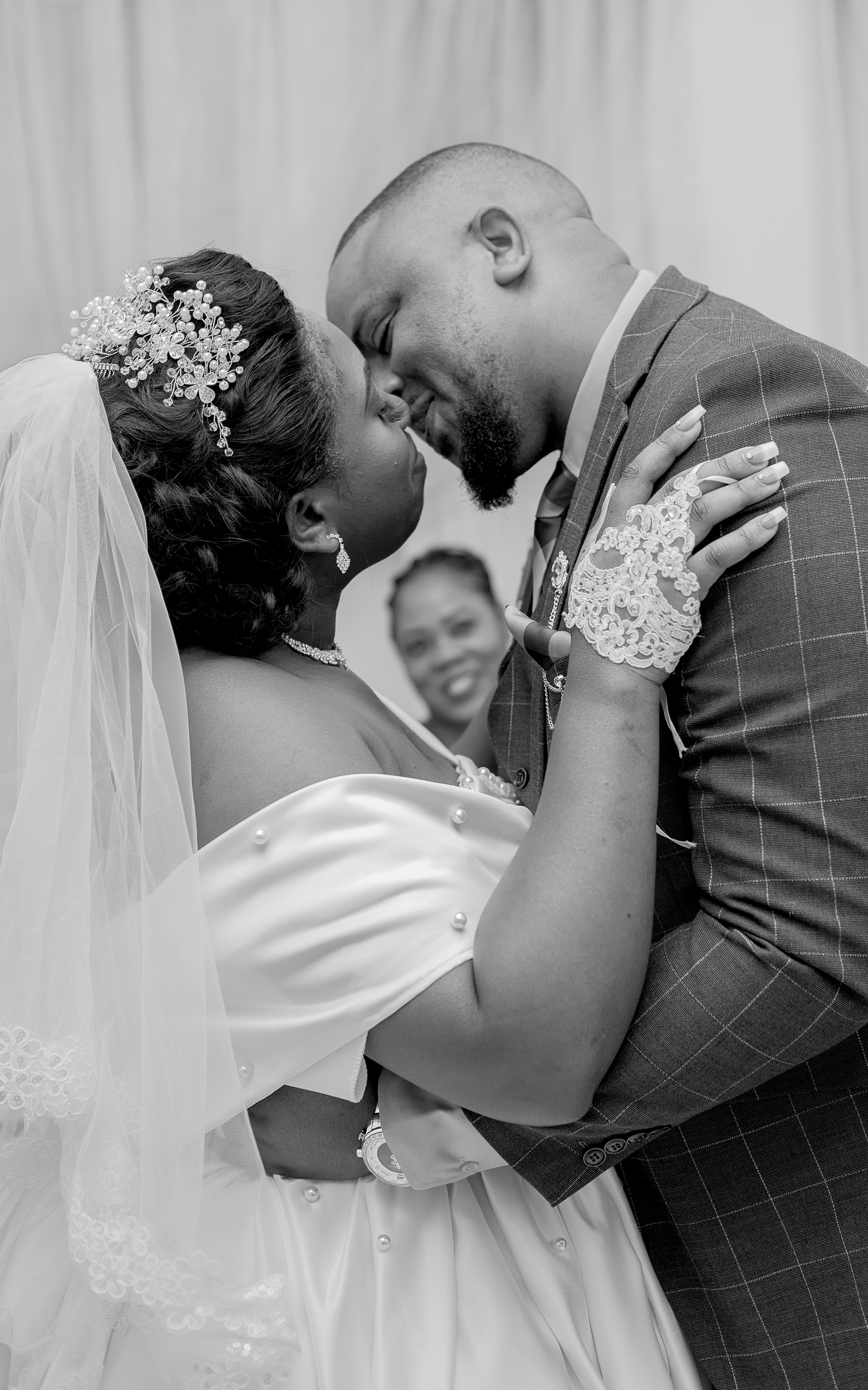A bride and groom share a kiss during their wedding ceremony.