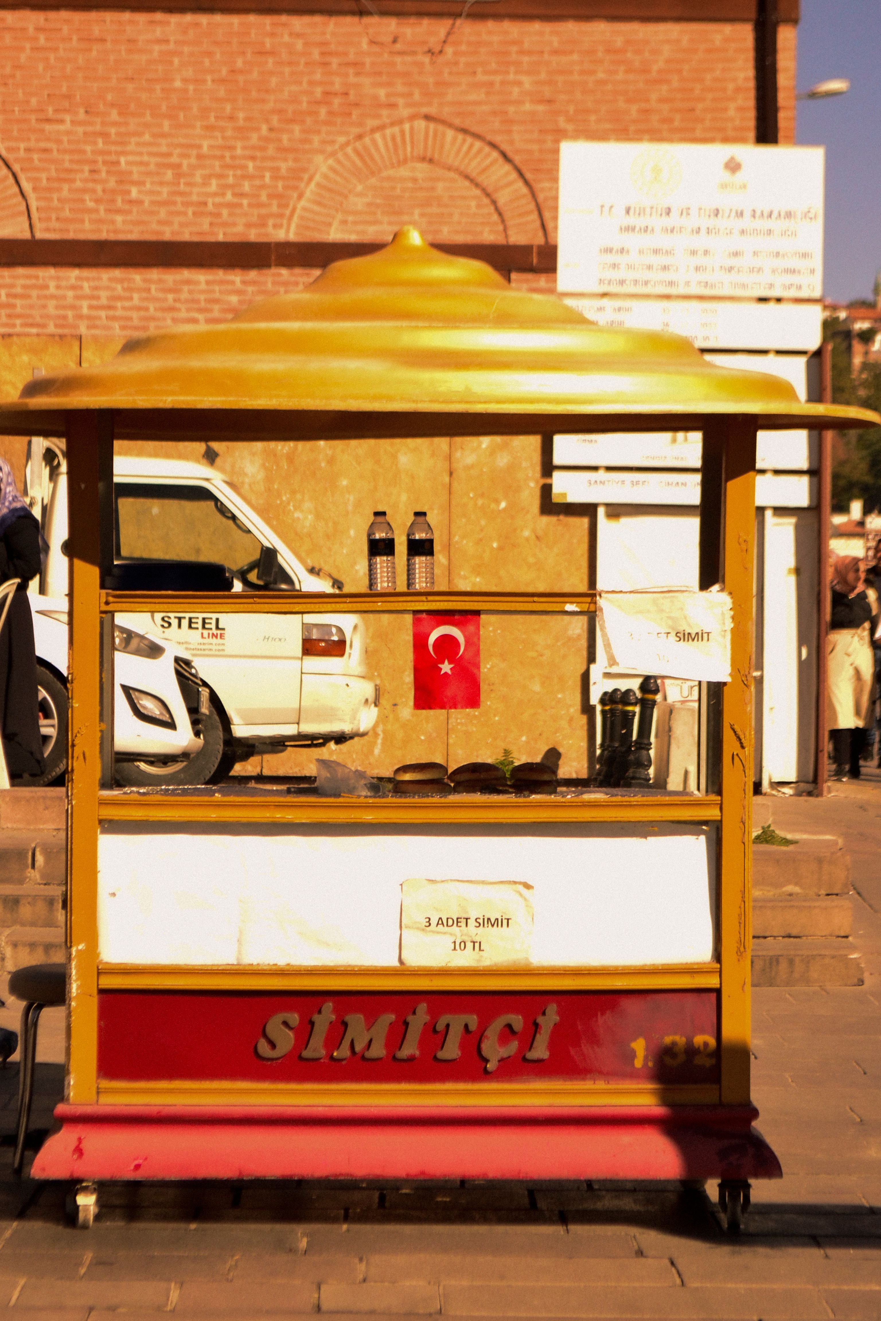 A traditional Turkish simit cart with pastries, decorated with national flag.