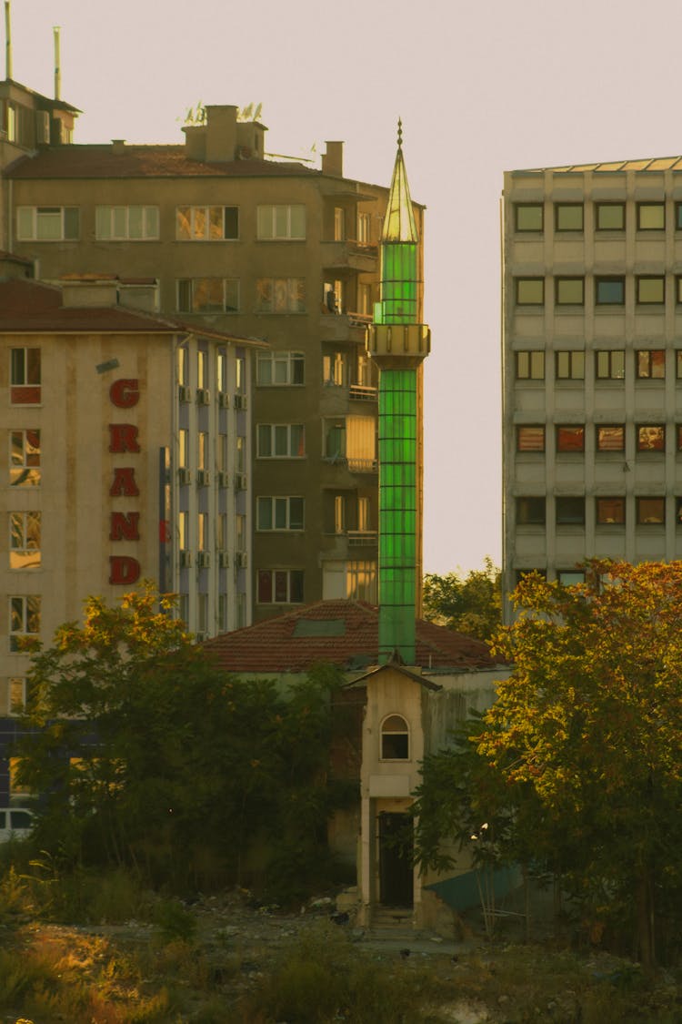 Glass Tower In Residential Buildings Area On Sunset