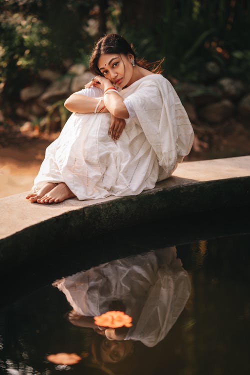 Woman Sitting over Water