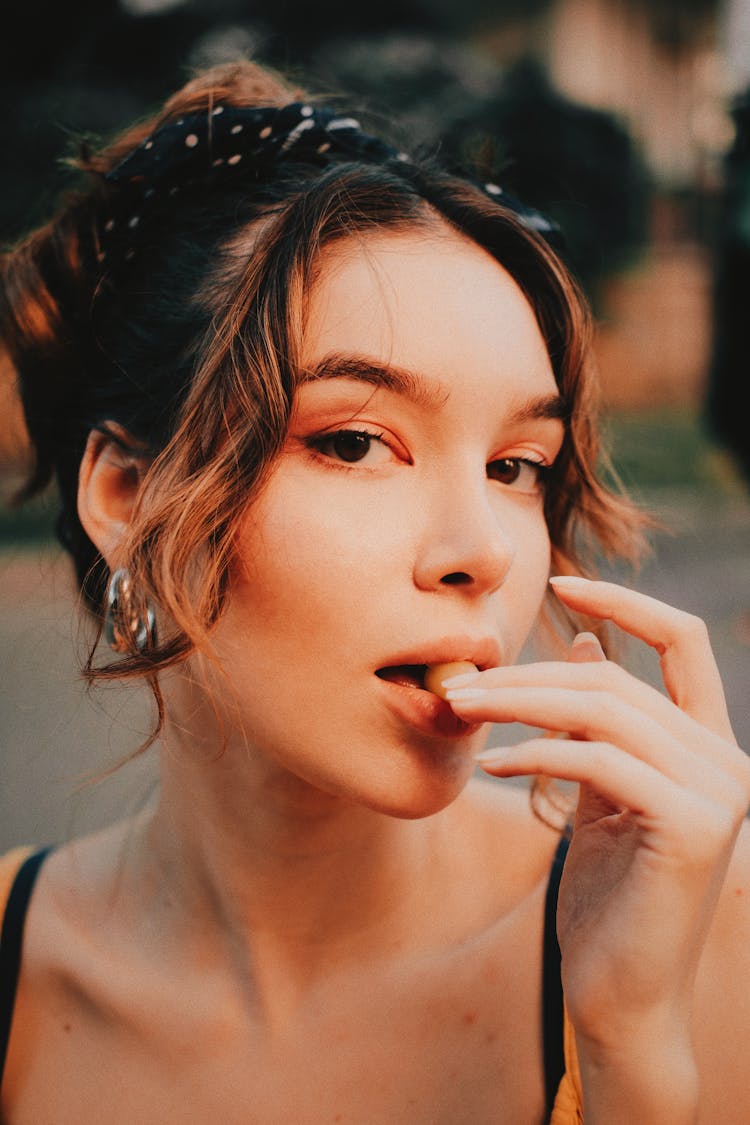 Brunette Woman Eating A Candy 