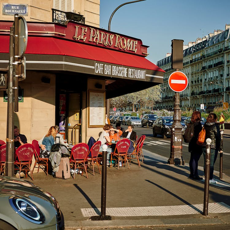 Tourist Sitting Outside Le Paris Coffee Bar And Restaurant