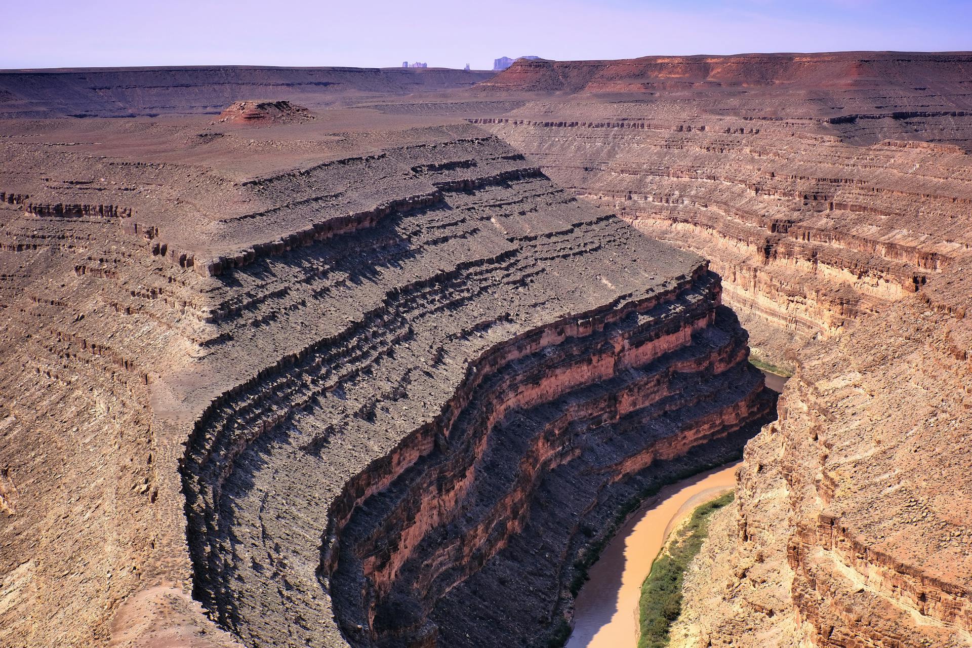 Drone capture of dramatic rock formations at Gooseneck Canyon with a winding river.