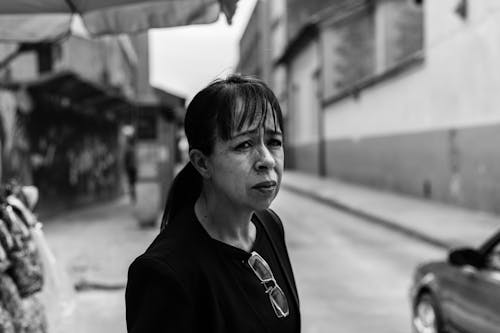 Grayscale Photography of a Woman with Bangs Looking Afar