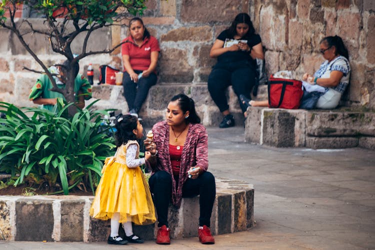 Mother Sitting With Daughter And Ice Cream