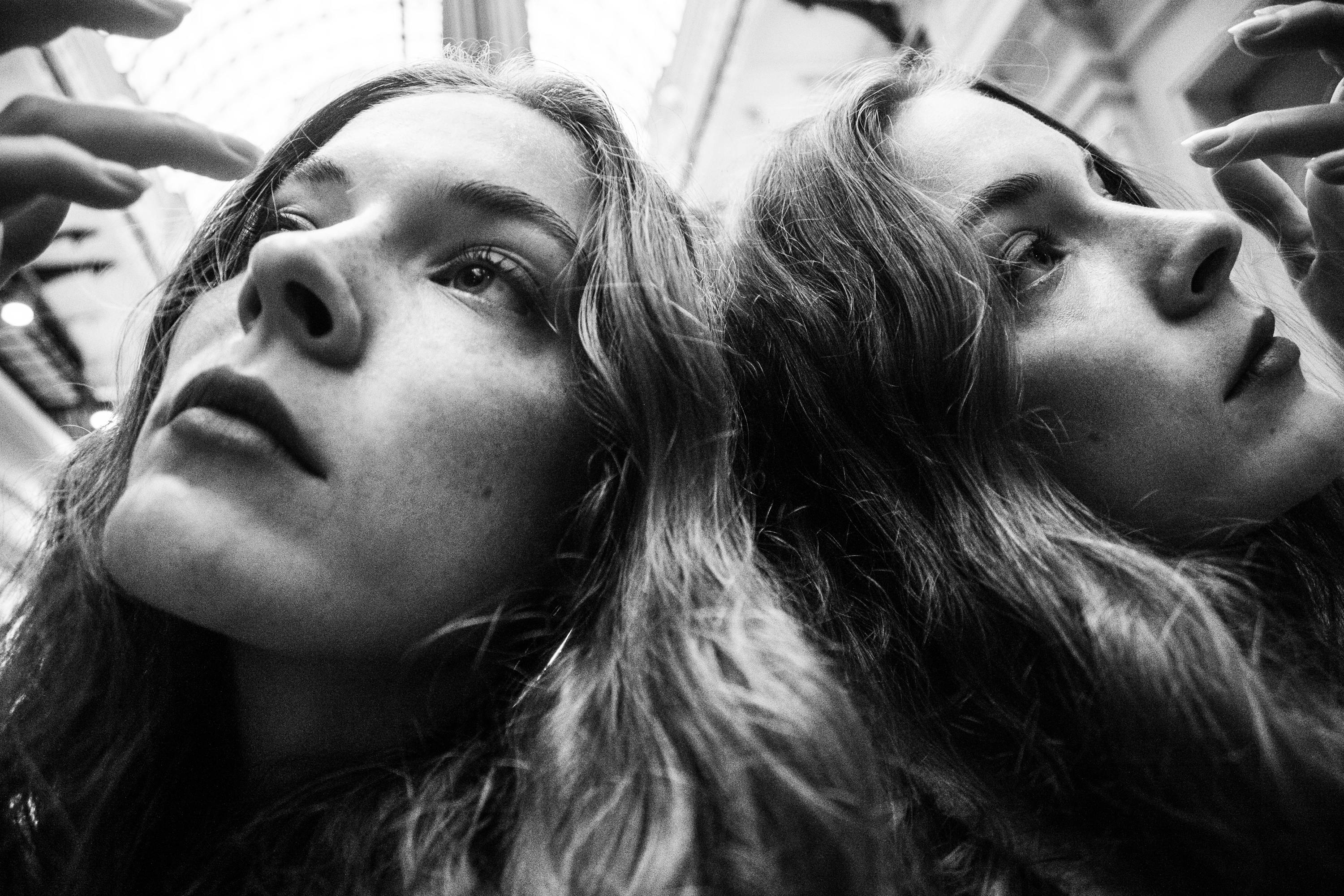 A Grayscale of a Woman Leaning on a Mirror · Free Stock Photo