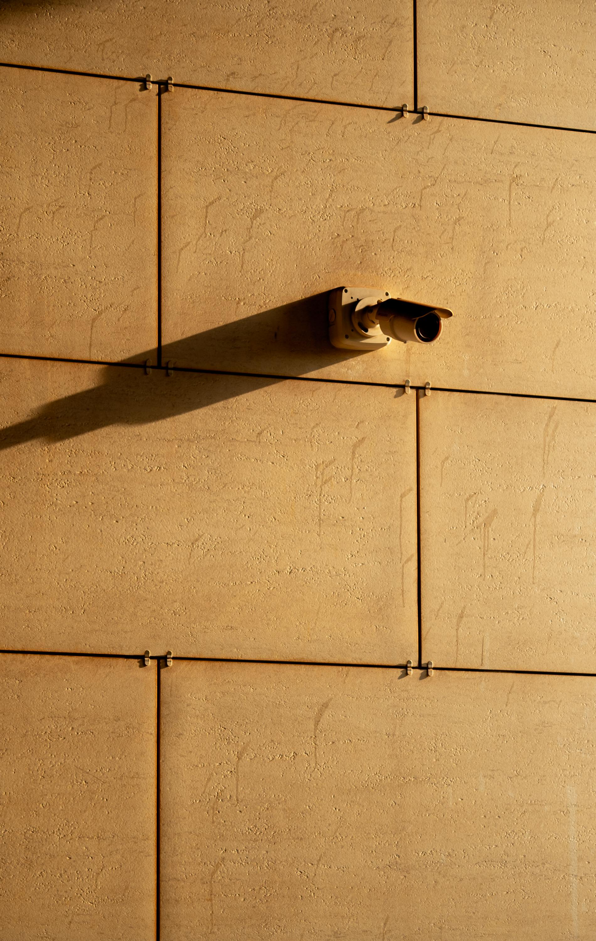 a cctv camera mounted on a concrete wall