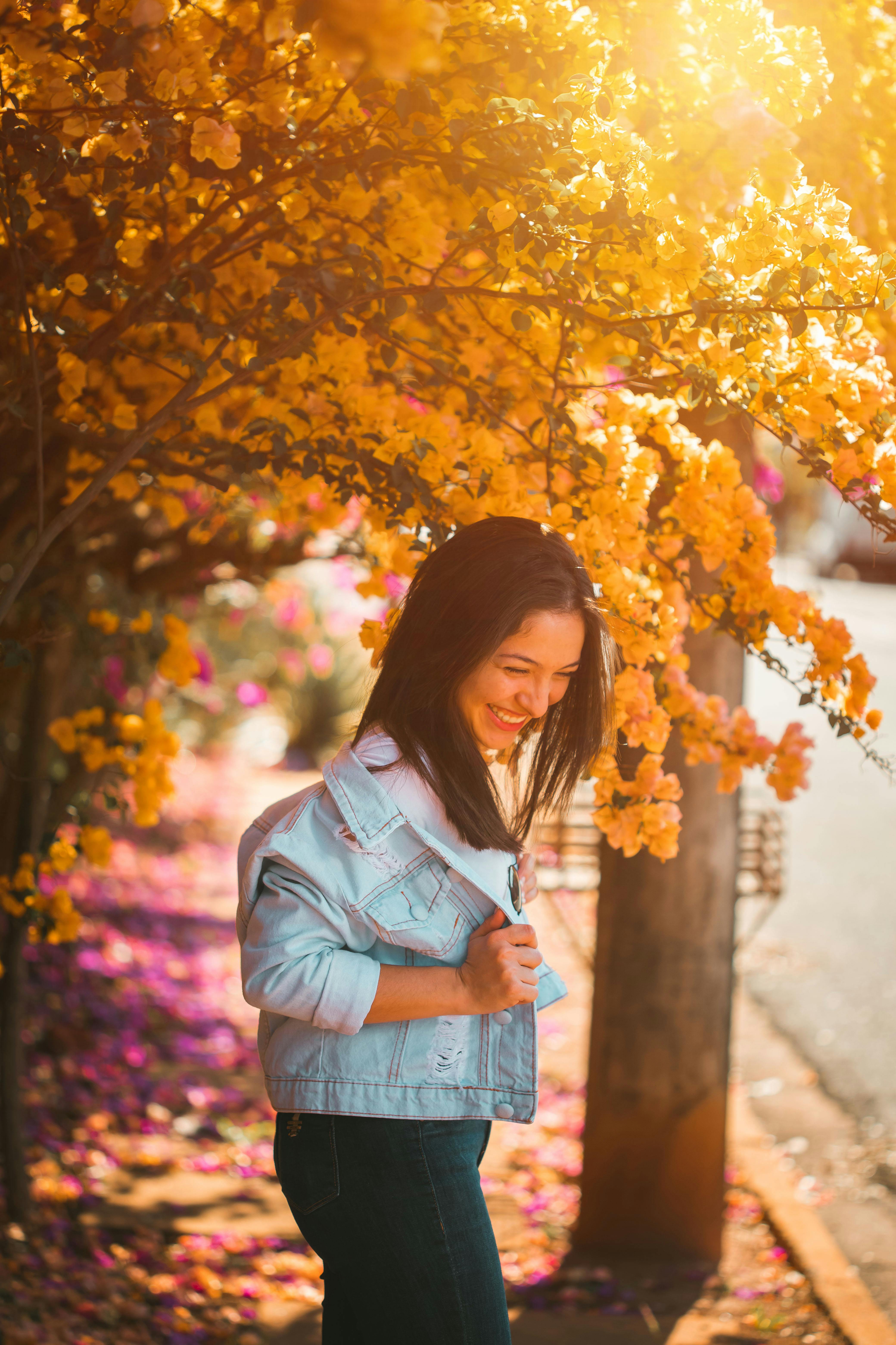 A Woman Smiling Under Flowers · Free Stock Photo
